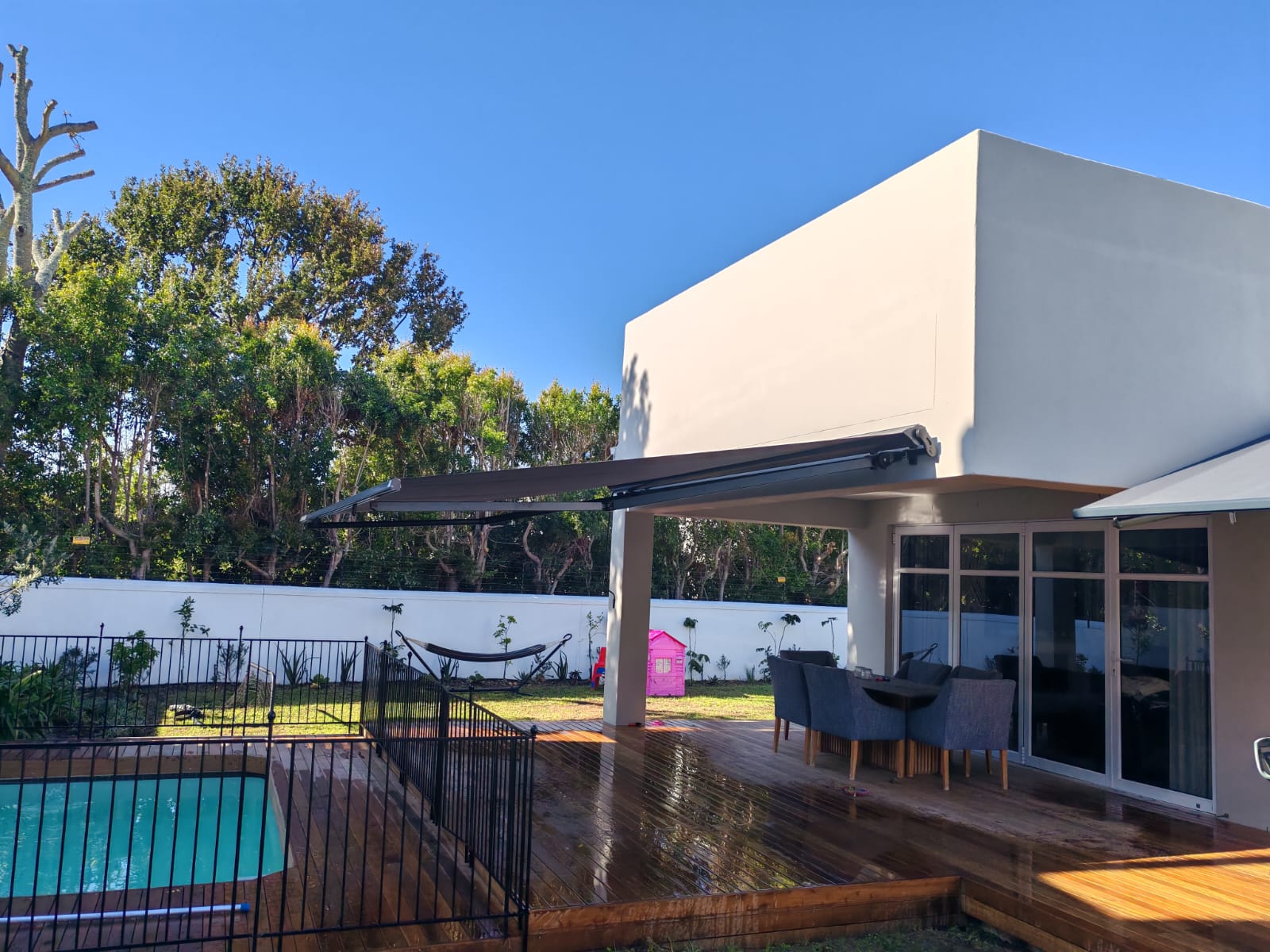 Retractable awning over pool and patio
