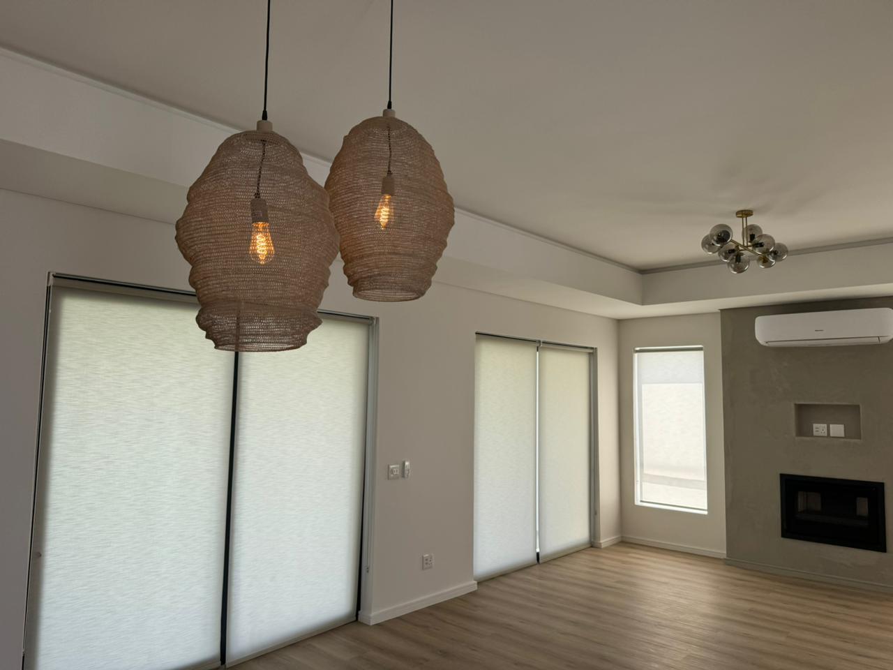 Warm tone roller blinds lounge fireplace