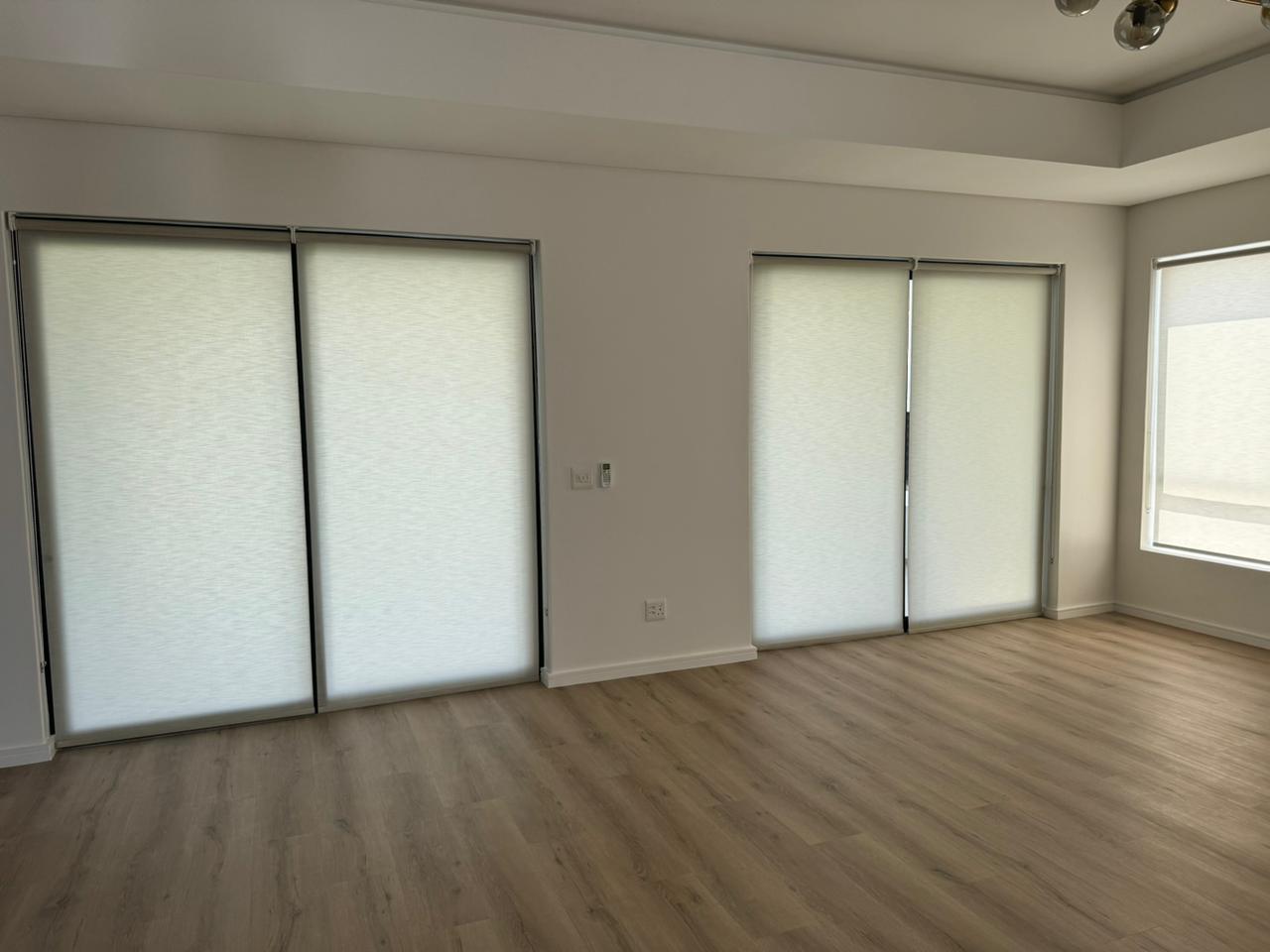 Clean bedroom white roller blinds natural light