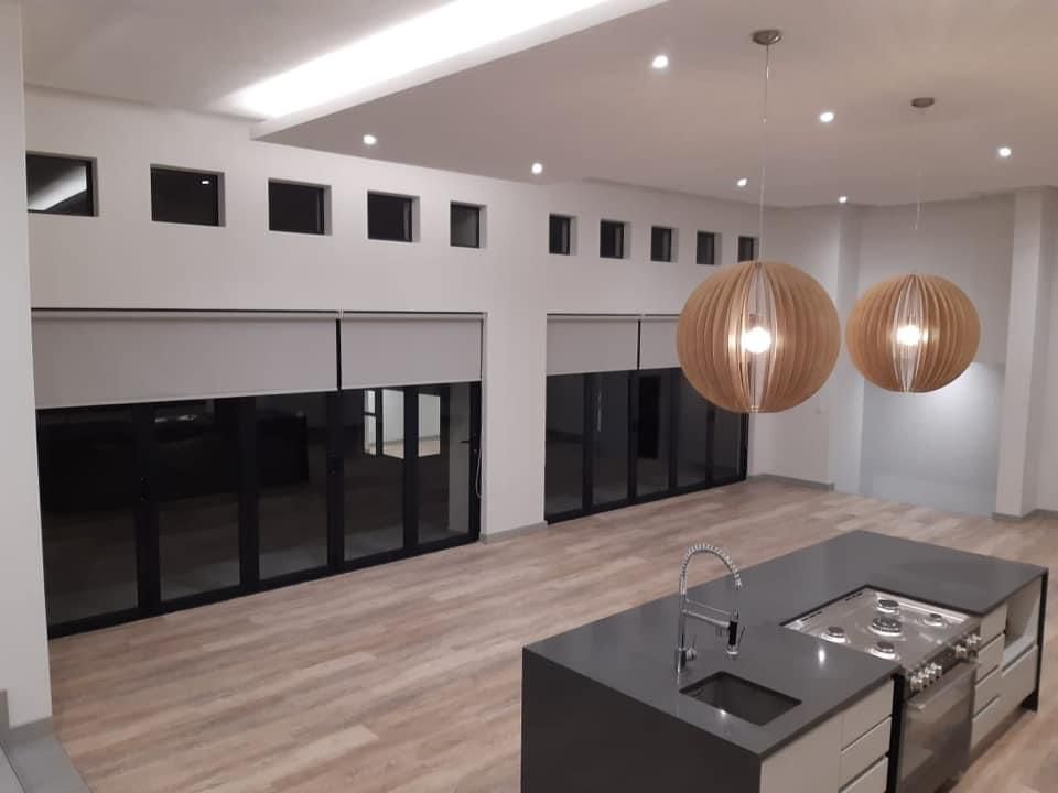 Open-plan lounge wooden pendant lights rollers