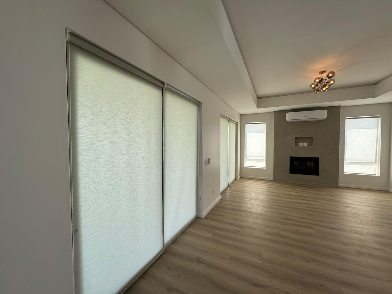 Spacious lounge white rollers fireplace chandelier